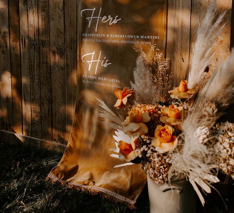 Signature cocktails suede fabric wedding sign dropped over the wooden bar 