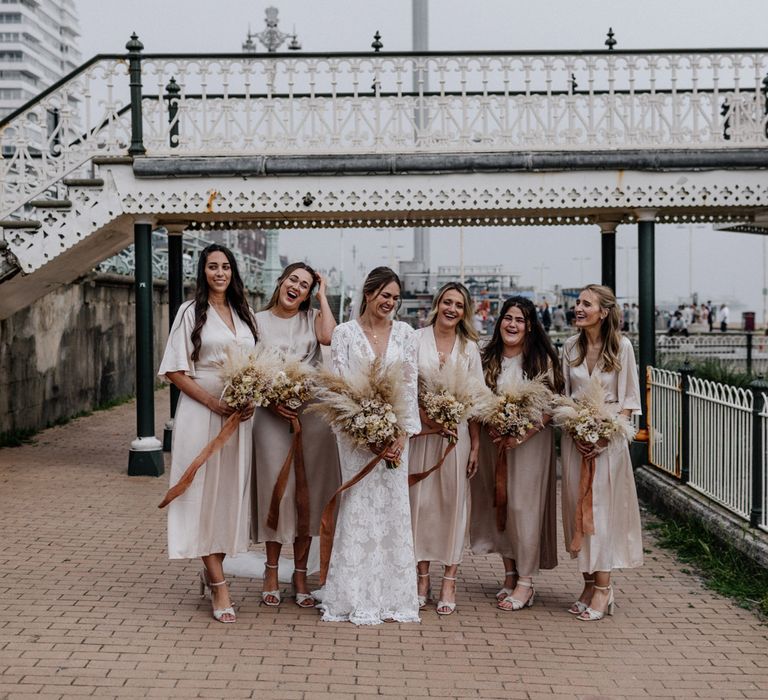 Champagne bridesmaid dresses and pampas grass bouquets at Brighton bandstand wedding