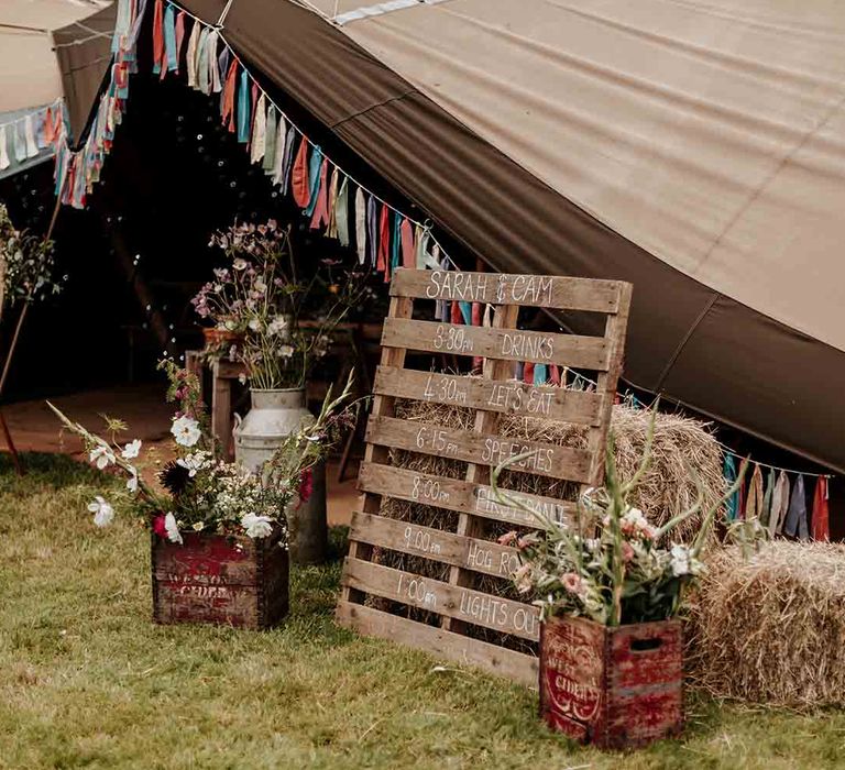 DIY wedding decor and wooden sign at festival style wedding