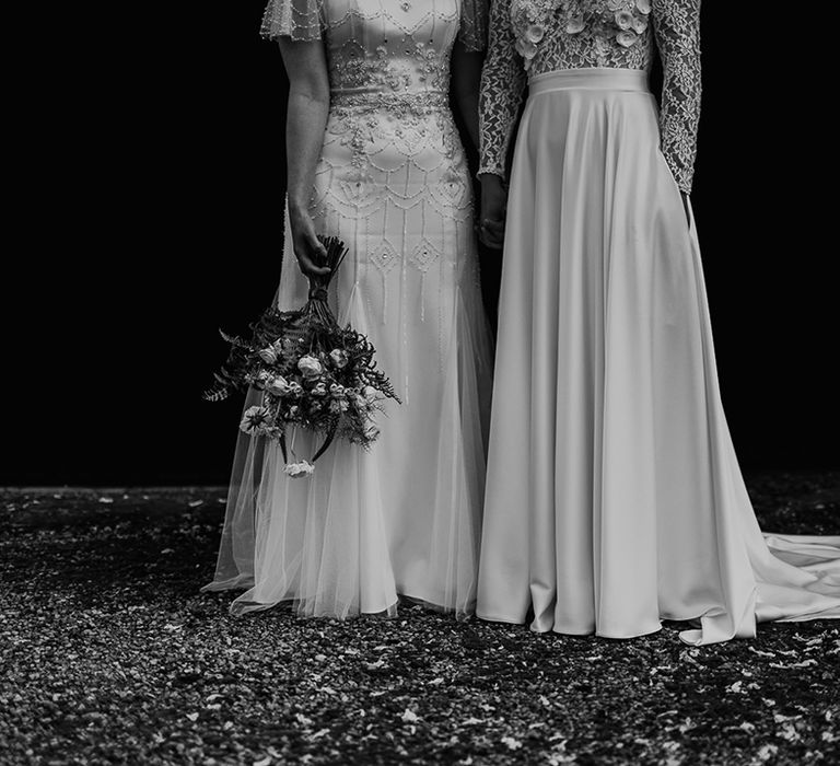 The skirt detail on the brides wedding dresses with a embellished overlay and sateen full skirt designs