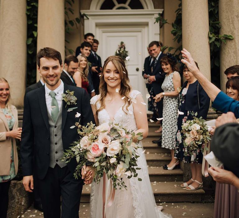 Confetti moment for bride and groom at country house venue