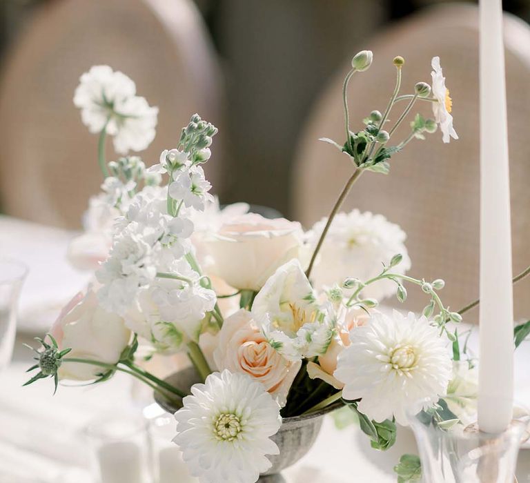 Pastel florals line simple table for outdoor reception