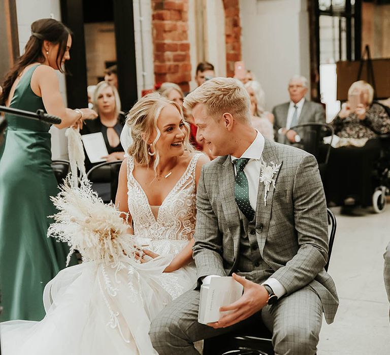 Bride and groom during civil ceremony at industrial venue