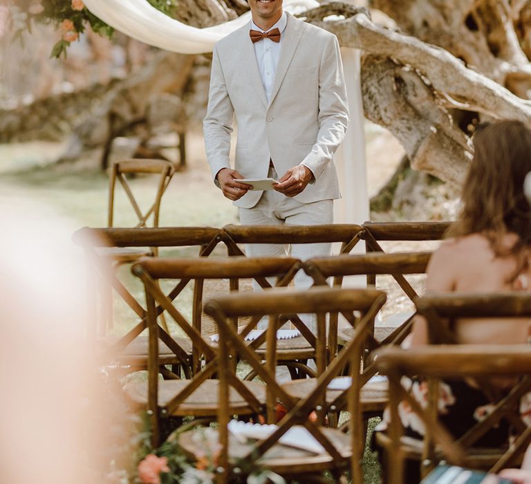 Smiling groom awaits the arrival of the bride 