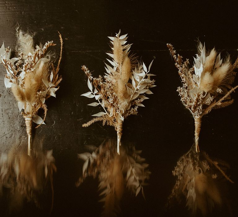 Groom and groomsmen buttonholes made from dried flowers for boho styled wedding 