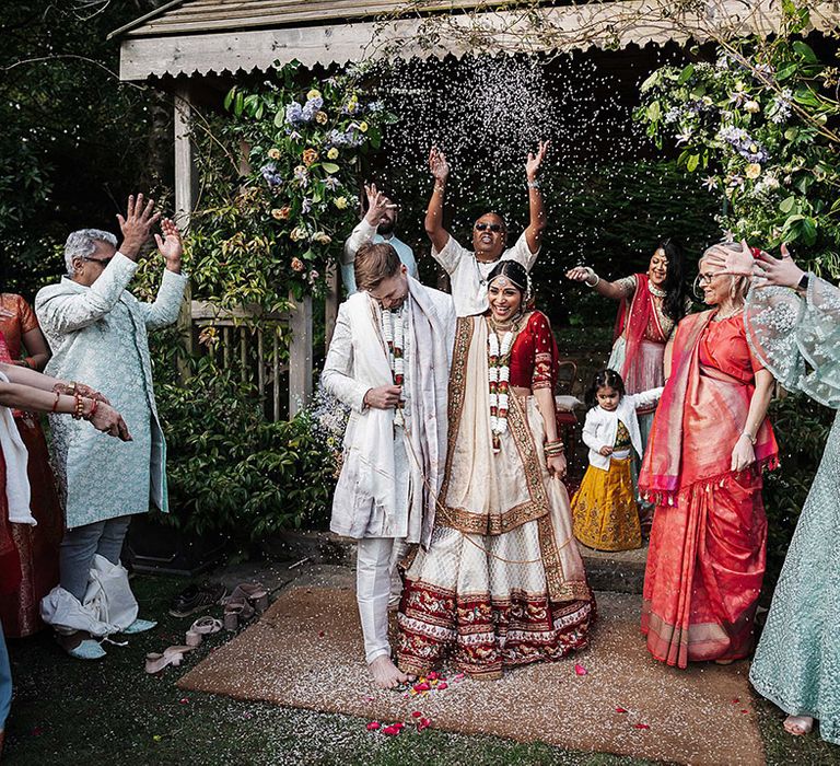 Bride and groom have confetti exit from their second wedding ceremony for multicultural wedding