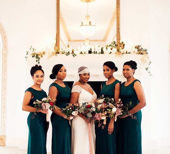 Bridesmaids in scoop neck forest green bridesmaid dresses with bride wearing a cap veil 