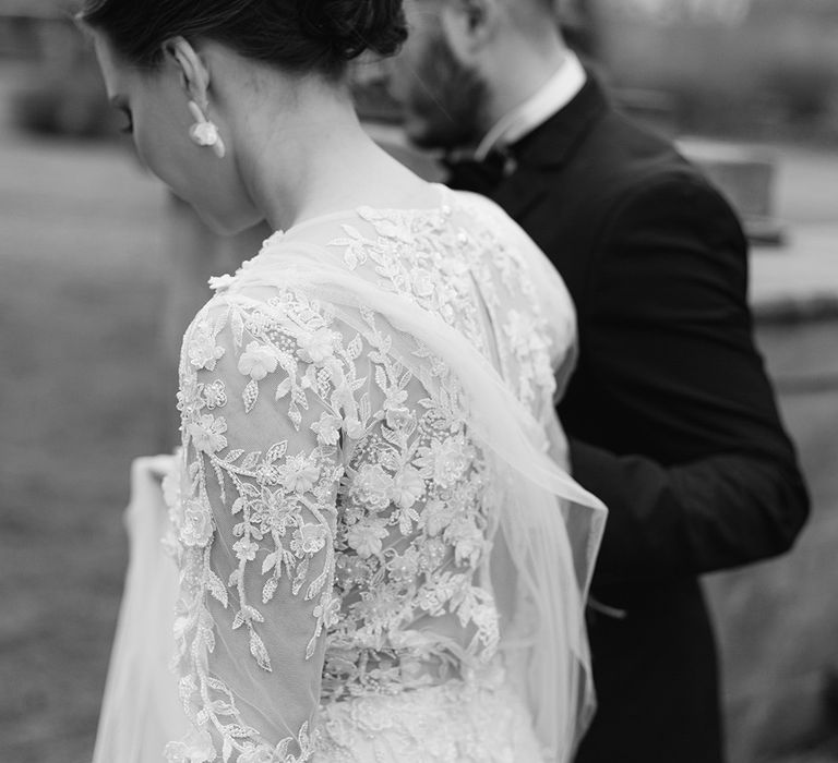 Chic bridal up do and detail on lace applique wedding dress 