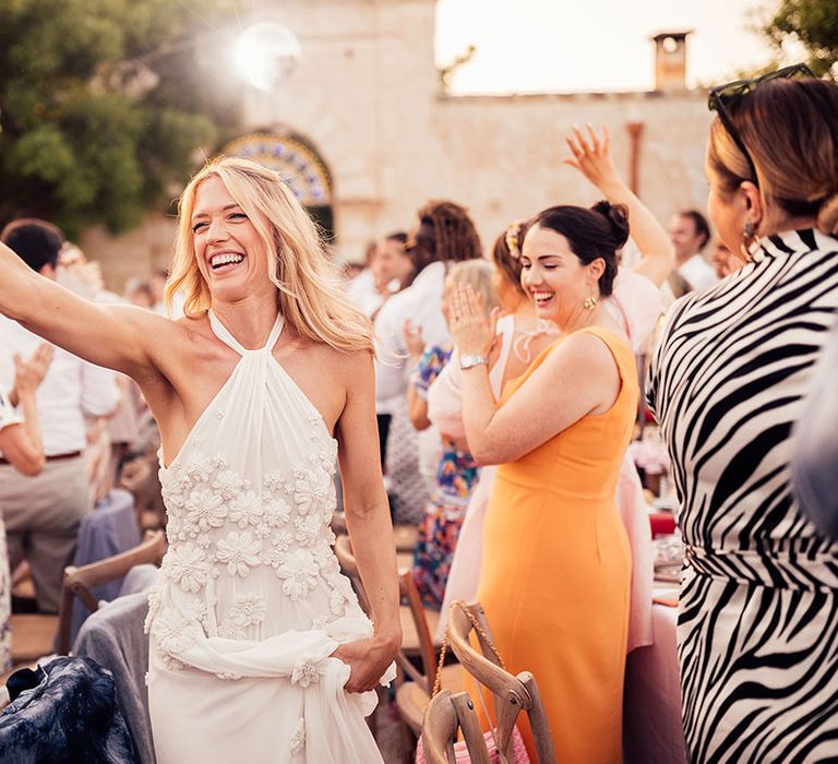 Bride high fives a wedding guest