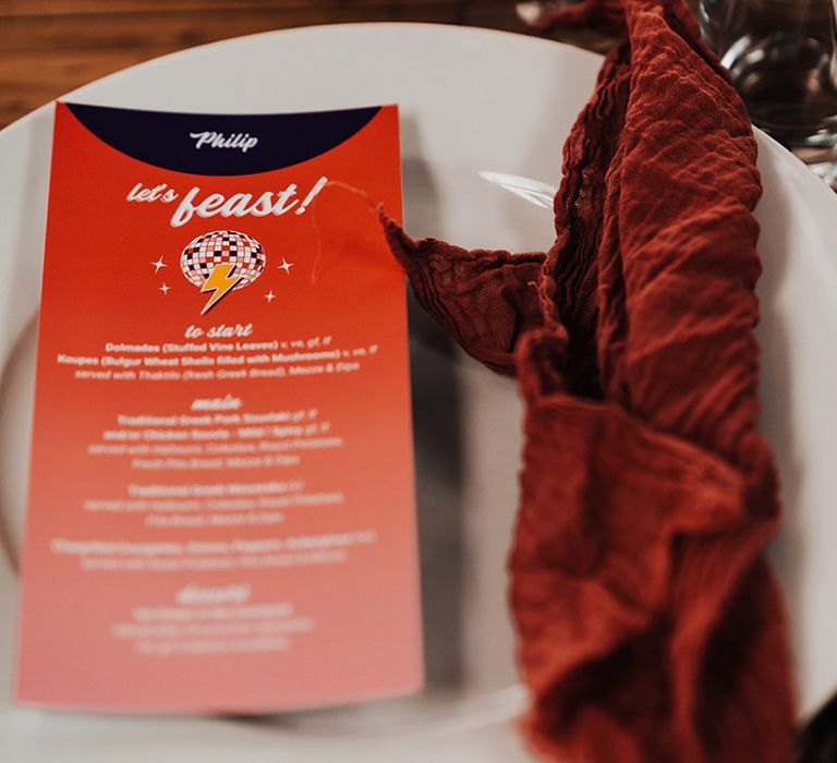 Red wedding menu stationery with red napkins table setting