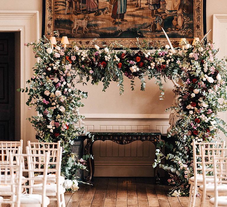 Pink, red and white rose wedding flower arch decorating Elmore Court 