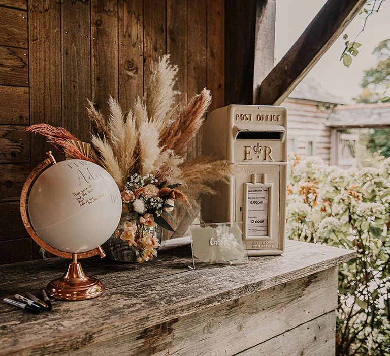 White post box for the wedding guests cards with an all white wedding globe alternative wedding guest book 