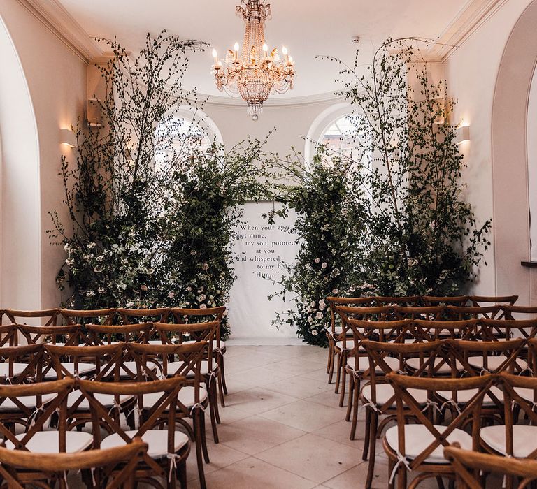 Iscoyd Park wedding ceremony room with large flower column arrangements and a black and white minimal wedding sign 