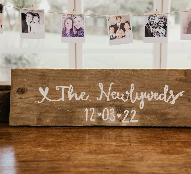 DIY wooden wedding signage with old polaroid pictures fro wedding decor 