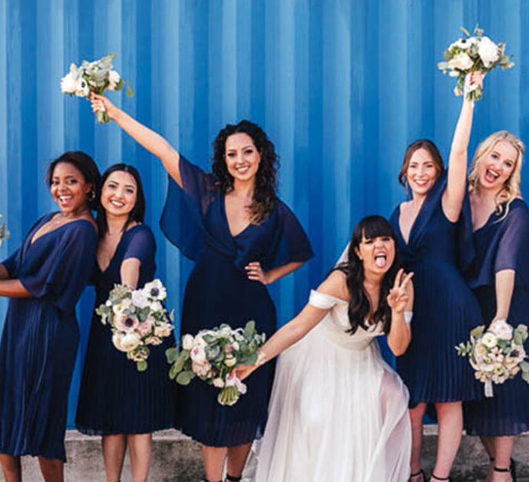 Navy blue bridesmaid dresses with pleated midi skirt with bride for modern Trinity Buoy Wharf wedding 