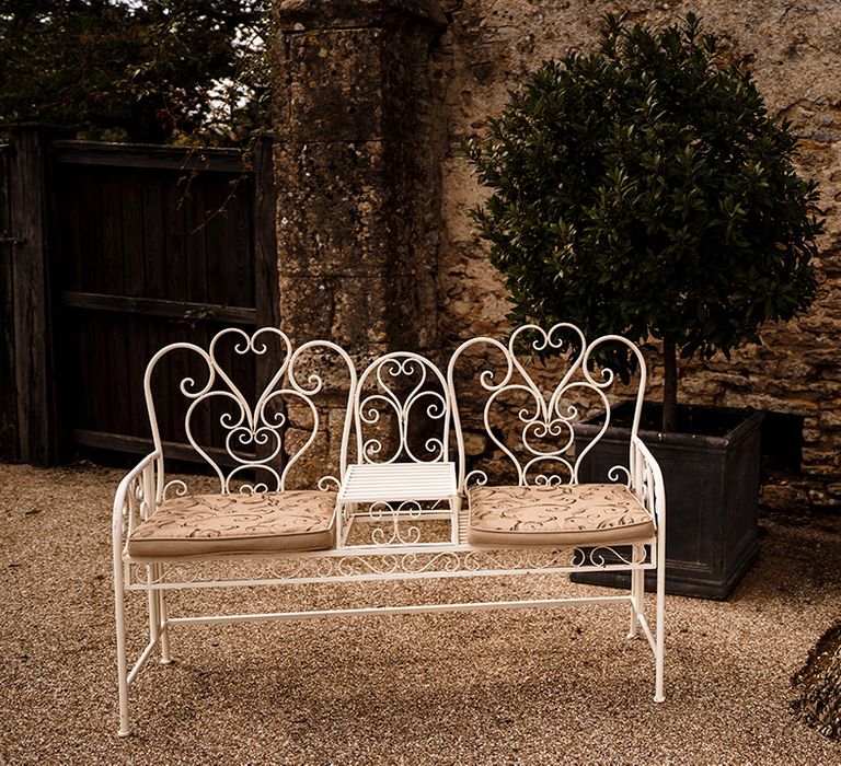 white garden bench for outdoor wedding at Caswell House Cotswolds wedding venue 