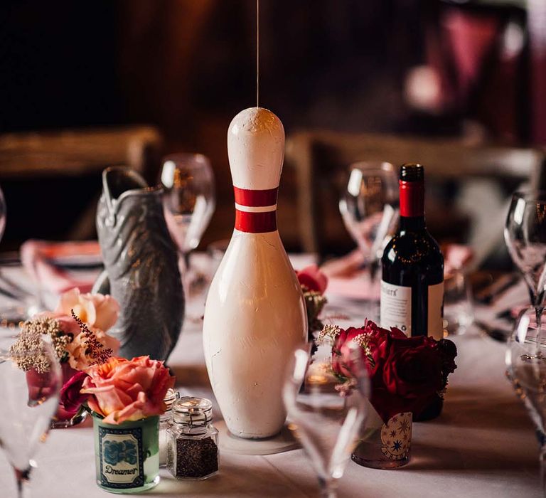 Fun bowling pin wedding table centrepiece with table number sign 