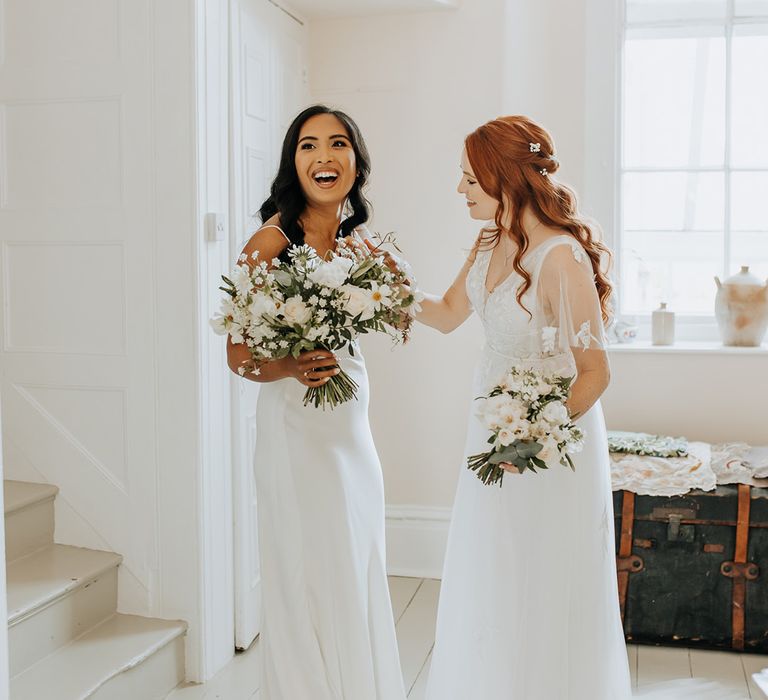 Same sex wedding with first look moment between the two brides in white wedding dresses