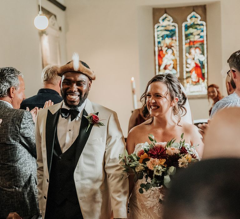 Multicultural wedding church ceremony with Welsh and African traditions 