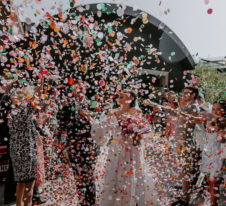 Bright colourful rainbow confetti moment for bride and groom at The Shack Revolution 