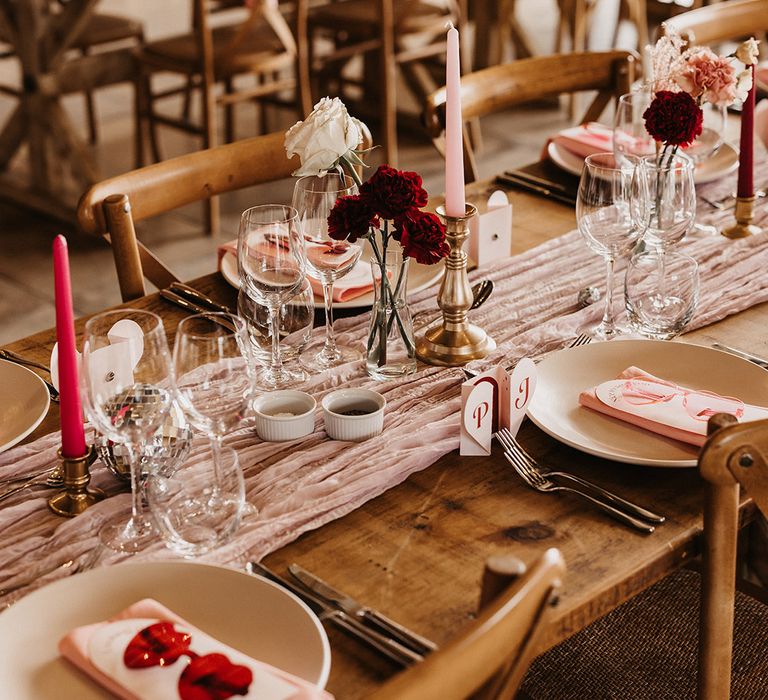 Pink heart shaped wedding decor with pink and red decor and sunglasses for wedding favours 