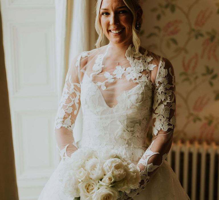 Bride in classic and elegant sheer high neck long sleeve lace wedding dress 