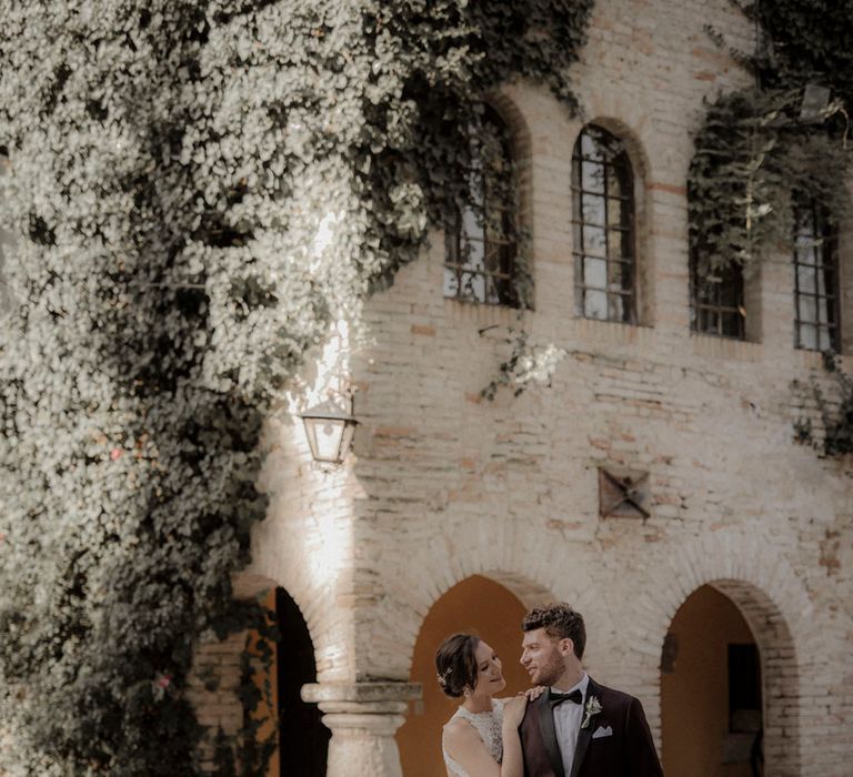 Italian villa destination wedding with bride and groom posing for couple portrait 