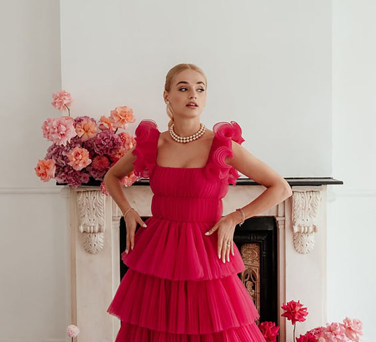 Woman wearing pink layered tulle dress surrounded by bouquets of flowers by Emma Olivia Photography