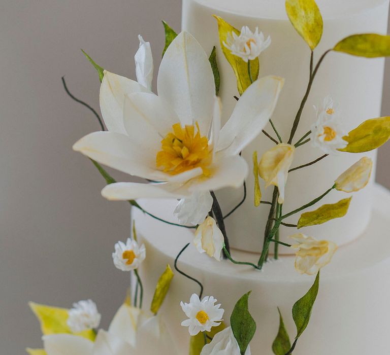 Sugar flowers handcrafted for summer wedding cake design on white wedding cake 