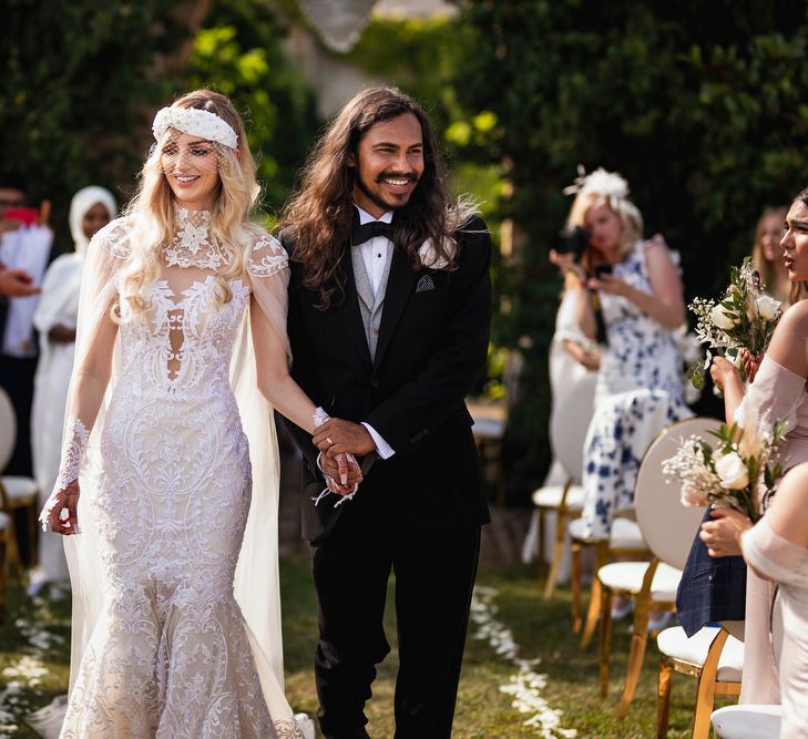 Bride and groom descending up the aisle as husband and wife 