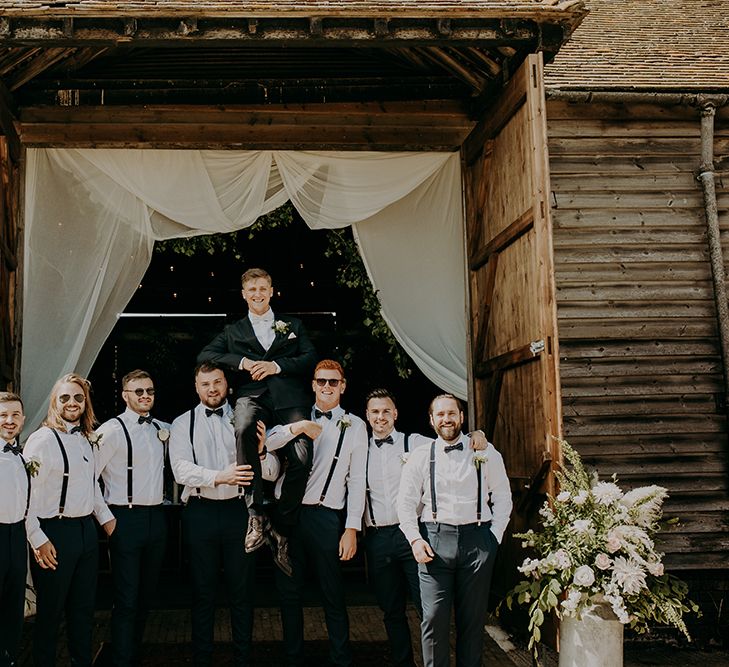 Groomsmen in white shirts and braces 