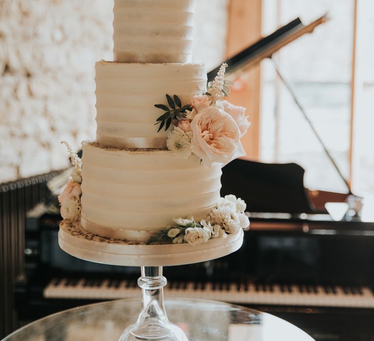 Classic buttercream wedding cake decorated with flowers 