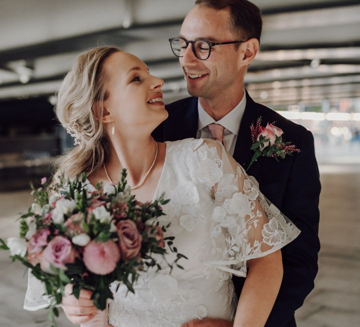 Bride clutches beautiful bouquet