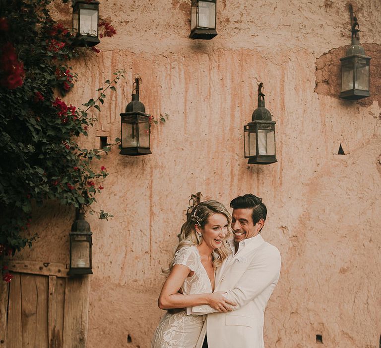 Bride in Berta wedding dress and groom in white dinner jacket at Marrakech wedding 