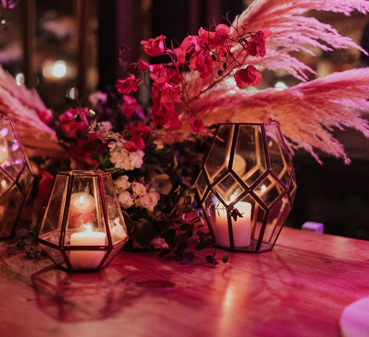 Gold lanterns and vibrant flowers at pink and blue wedding