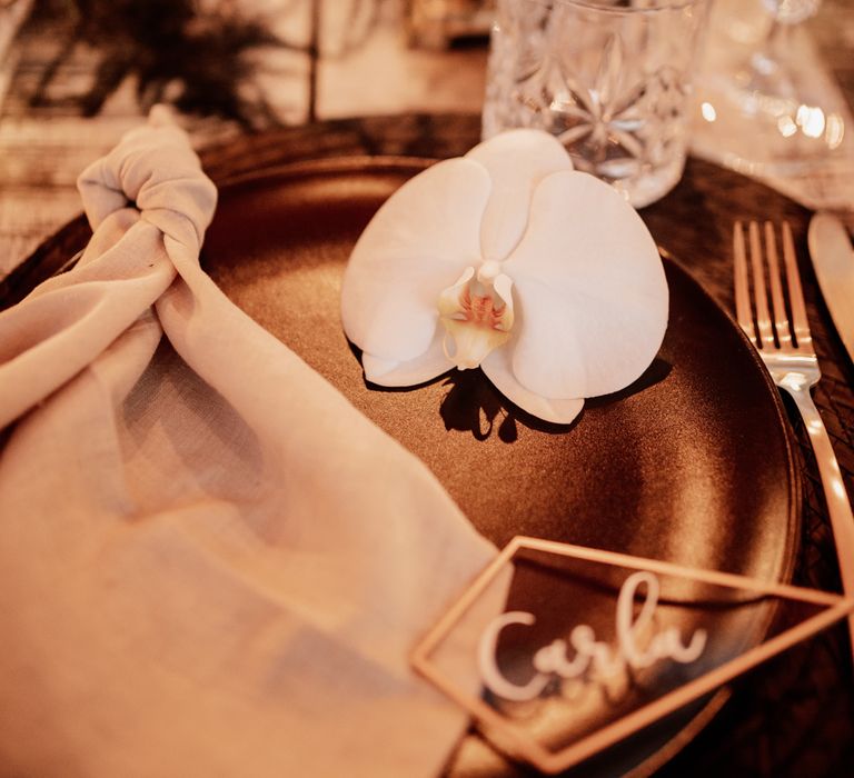 Golden table decor with orchid 