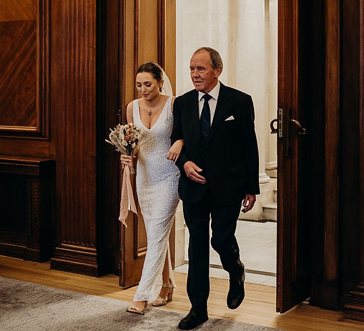 Grandfather walking his granddaughter down the aisle 