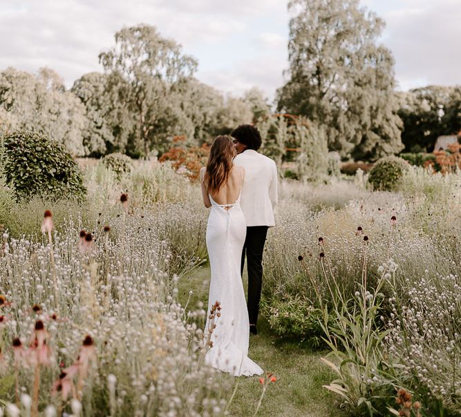 Bride in a white sequin wedding dress with backless design