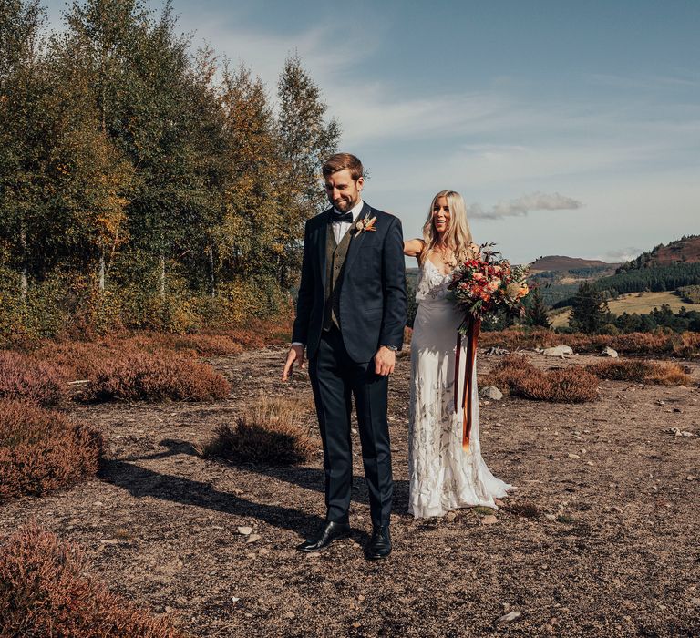 Bride & groom walk through the countryside in Scotland