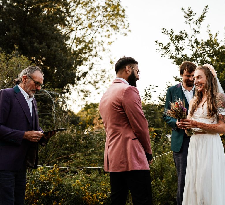 Bride & groom during wedding ceremony outdoors