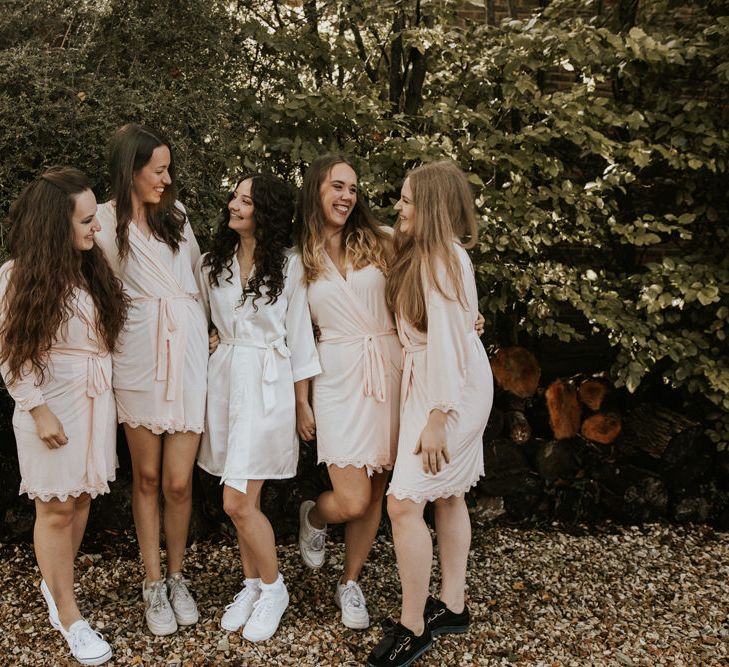 Bridal party on wedding morning in pink getting ready robes