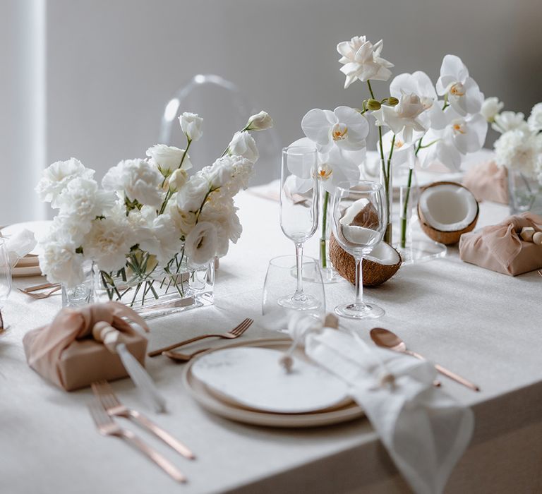 All-white floral centrepieces at minimalist Asian Lesbian wedding reception 