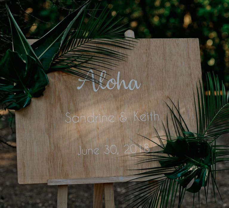 Aloha wedding sign at Polynesian inspired decorated wedding 