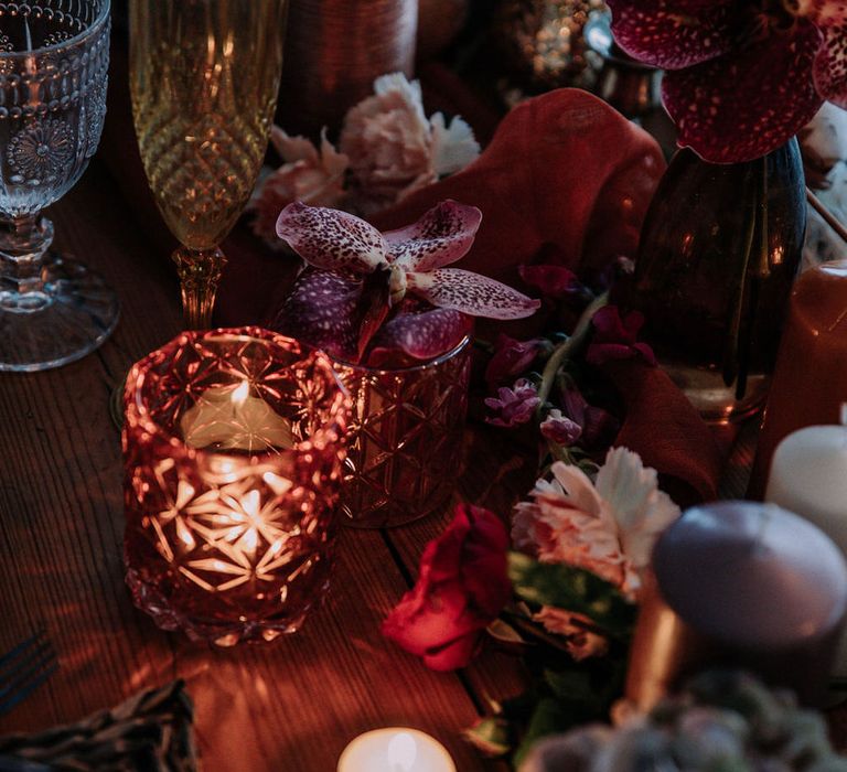 Rose gold tea light holders, pink orchids and gold champagne flutes for romantic beach wedding