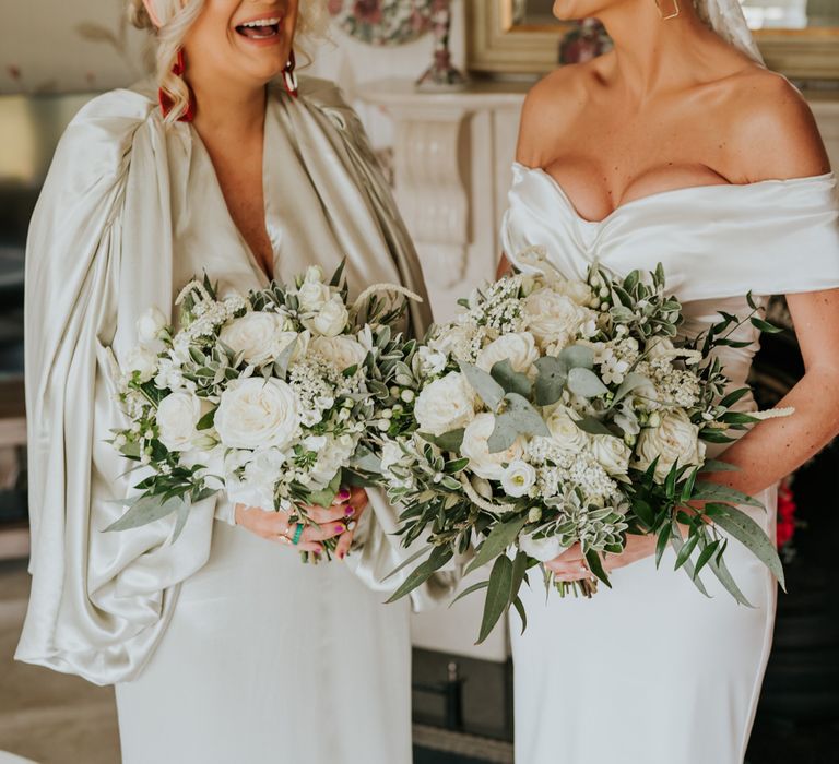 Bride with bridesmaid and white flower bouquets