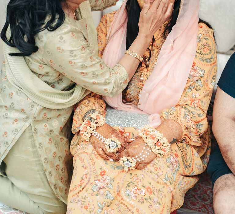 Bride during the traditional Haldi ceremony in which she is covered in turmeric paste for good luck and prosperity 