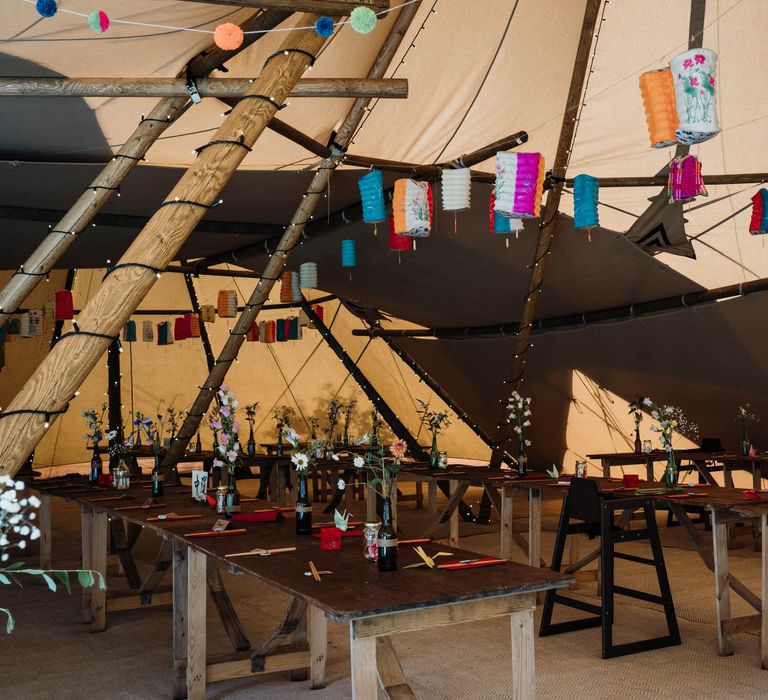 Rustic tipi complete with colourful hanging Chinese lanterns and relaxed vibe