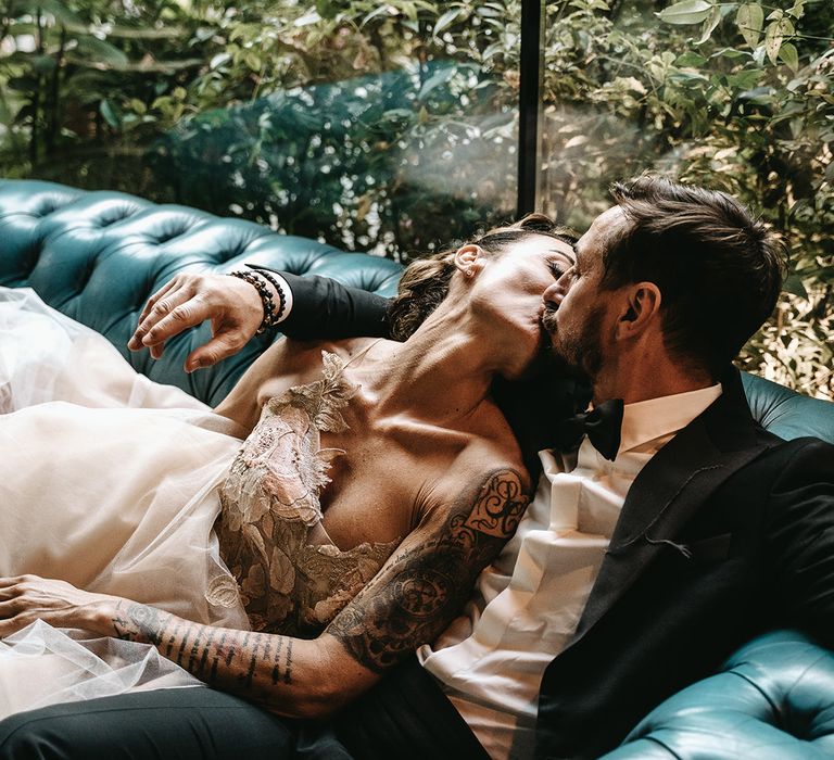 Bride & groom look lovingly at one another as they sit together on their wedding day