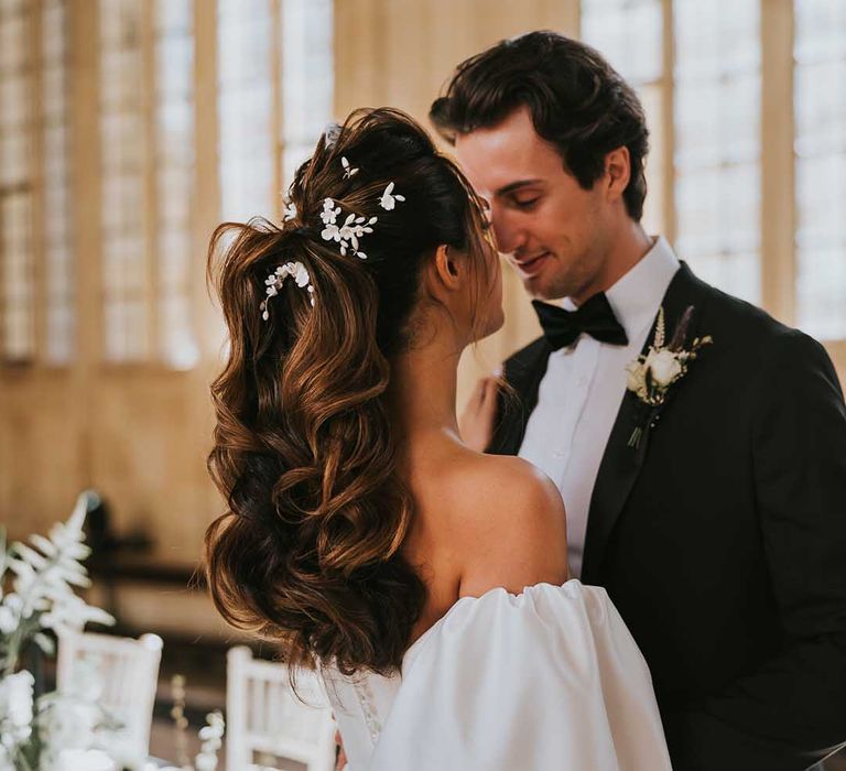 Bride with a wavy high ponytail wedding up do with white hair pins 