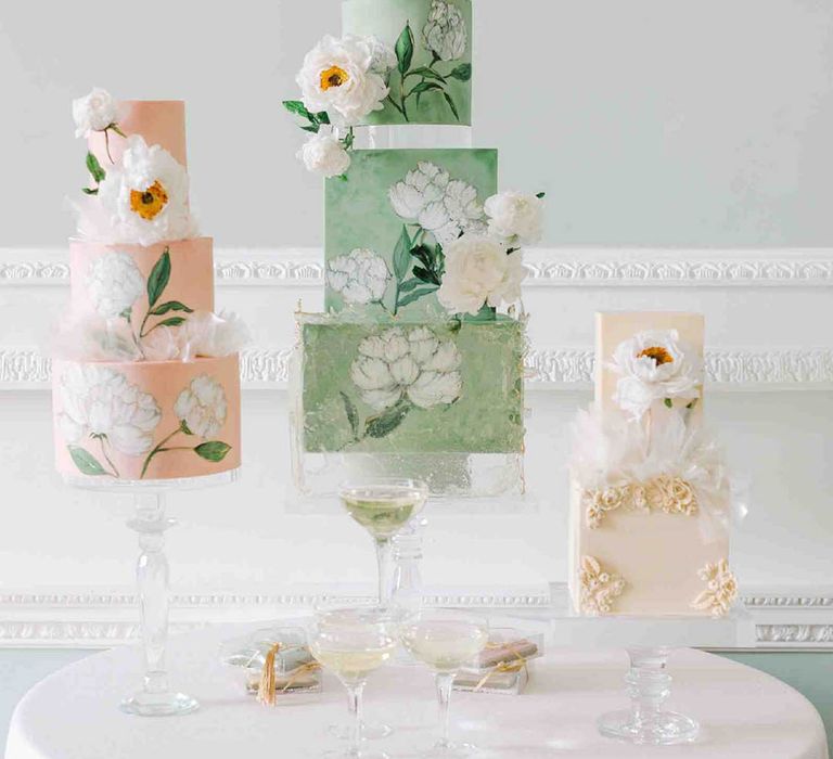 Four tier pale green wedding cake with square and round layers and flower illustration 